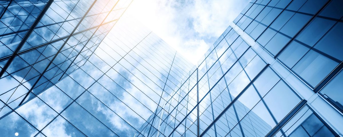 glass buildings with cloudy blue sky background